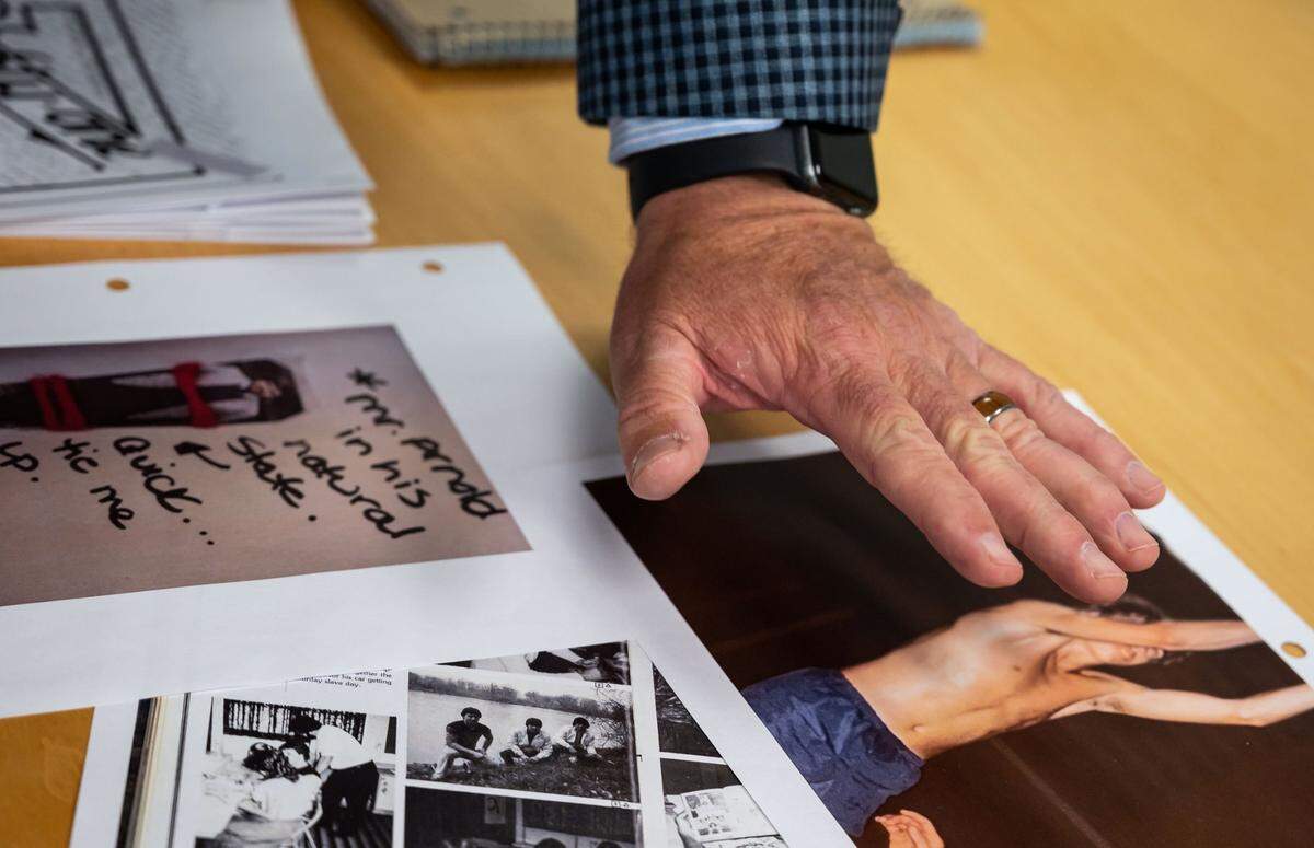 Scott Sorgea points to a shirtless photo of himself playing basketball in high school, which he said was taken by former Capital Christian School coach and teacher Dave Arnold.