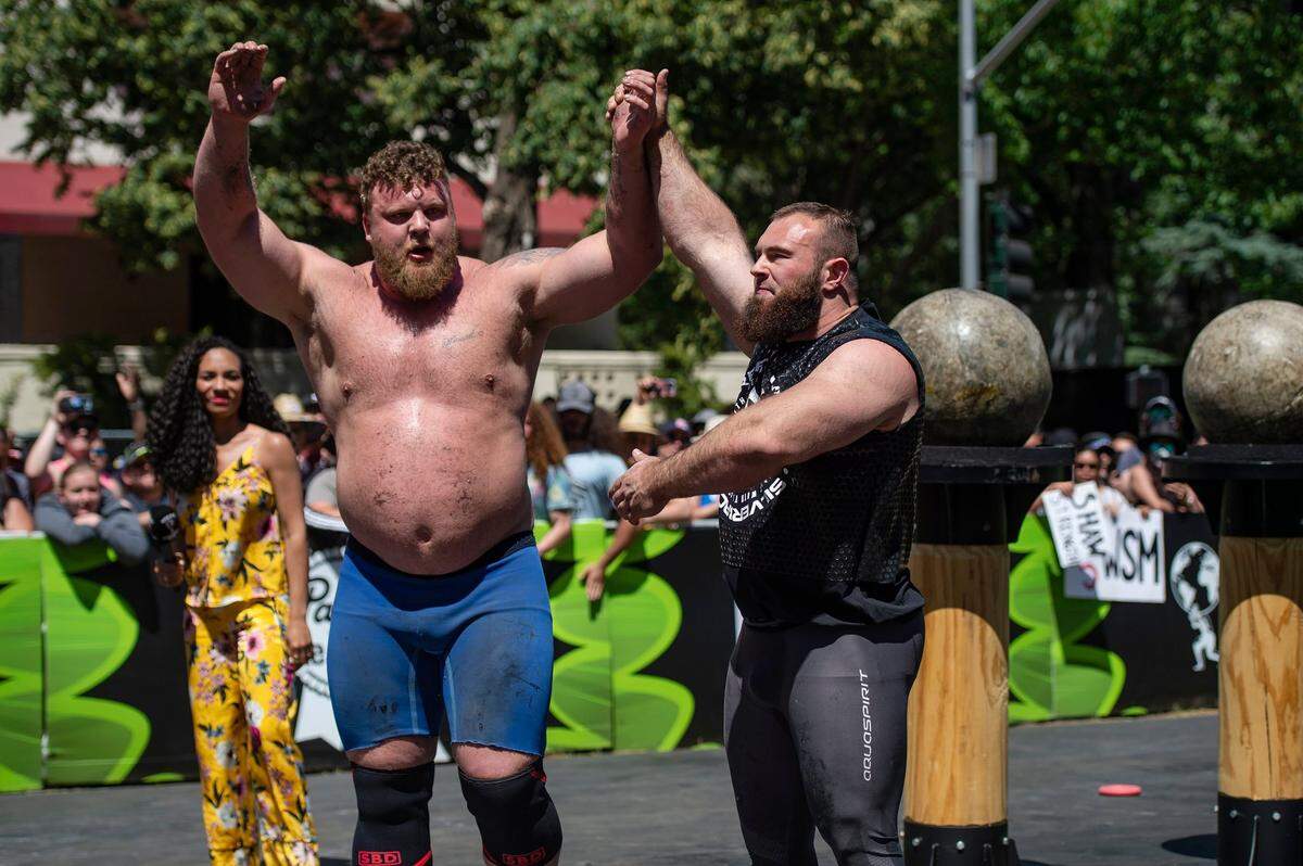 Oleksii Novikov, right, of Ukraine, lifts the arms of Tom Stoltman, of Great Britain, who placed first in the Worlds Strongest Man competition at Capitol Mall on Sunday, May 29, 2022, in downtown Sacramento.