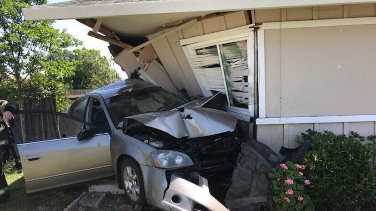 A four-door sedan ran into a home near the corner of Valley Hi Drive and Valley Green Drive Tuesday, injuring the car's two occupants. 