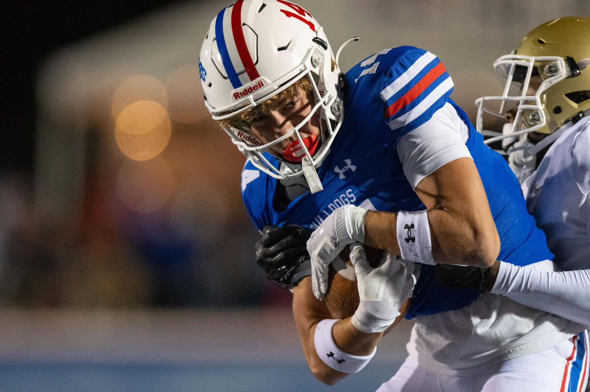 The Folsom Bulldogs’ Rob Larson (14) holds on to a pass for a short gain against the Long Beach Poly Jackrabbits in 2024.