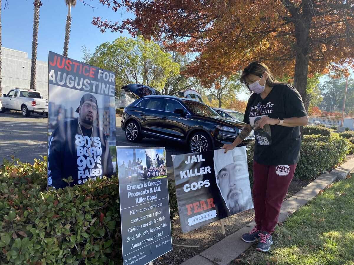 Roxanne Morales sets up picket signs Monday, Nov. 14, 2022, as she prepared for a protest to call attention to the death of her son Augustine Morales who was shot by police outside a boxing event in November 2020 in Sacramento, Callifornia.