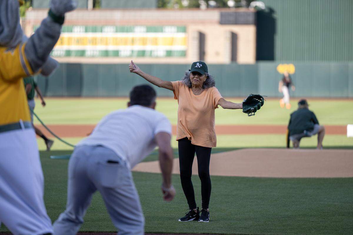 Nina Santangelo throws the ceremonial first pitch to her son, broadcaster F.P. Santangelo, on her 80th birthday before the Athletics hosted the San Francisco Giants at Sutter Health Park on Saturday, May 16.