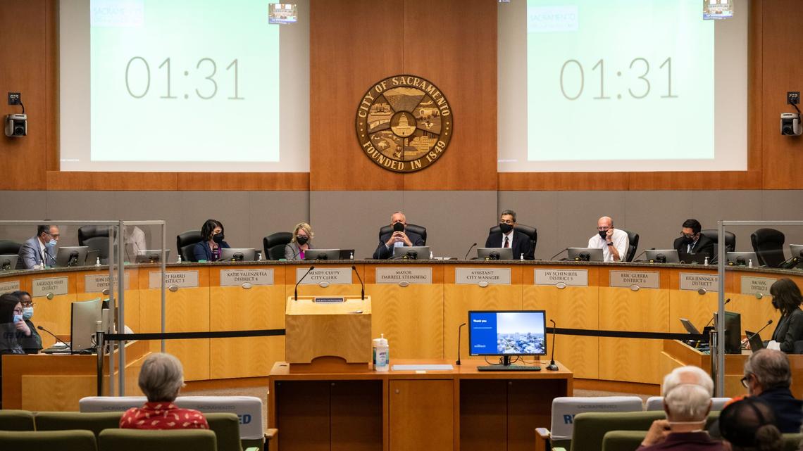 Mayor Darrell Steinberg, center, City Council members and staff listen to public comment over Zoom during the Sacramento City Council meeting Tuesday, Aug. 16, 2022, the first meeting back open to public attendance at City Hall since the beginning of the COVID-19 pandemic. Much of the meeting and public comment focused on the citys climate goals.