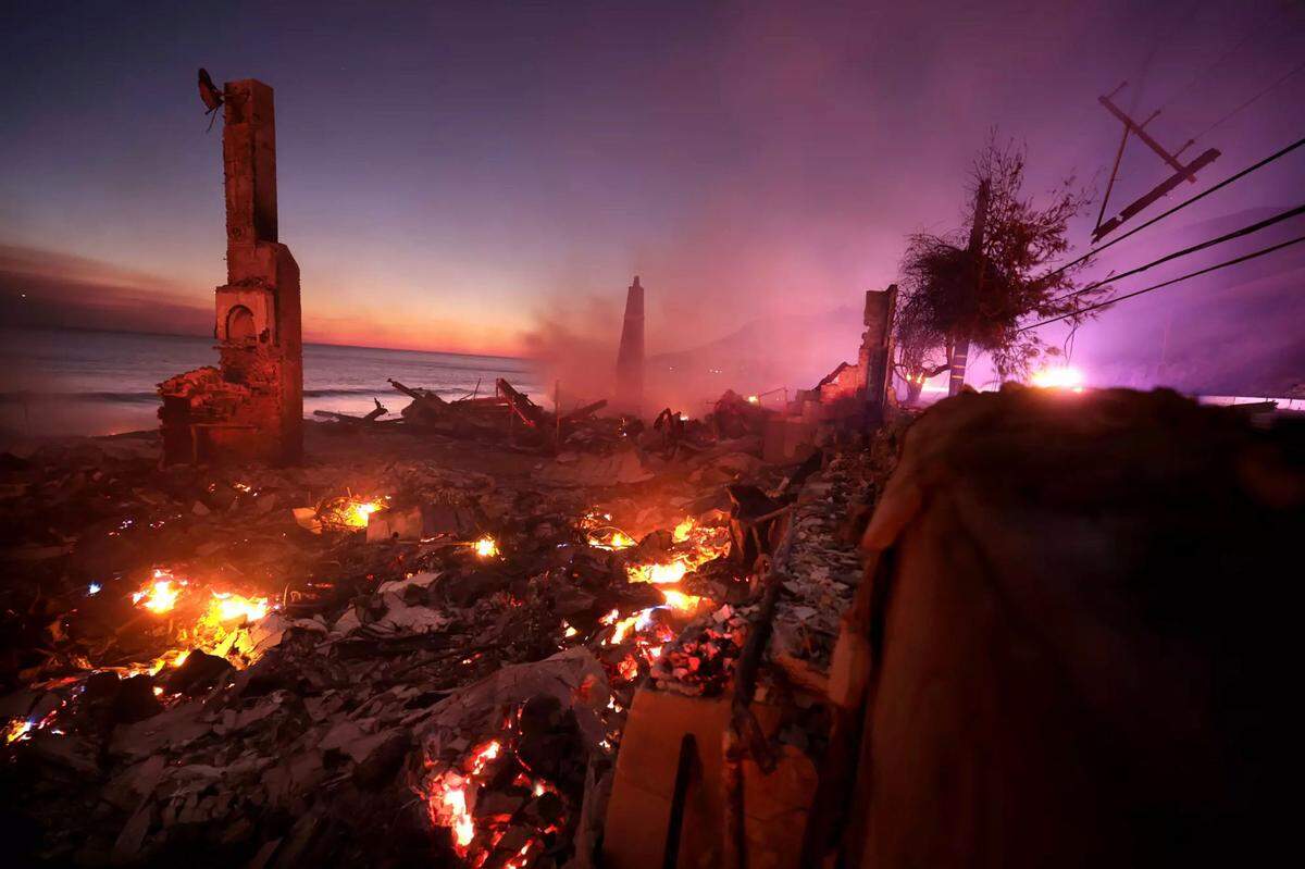 A house burns along the Pacific Coast Highway as the Palisades Fire burns in Malibu on Wednesday, Jan. 8, 2025. The blaze took 24 days to contain.