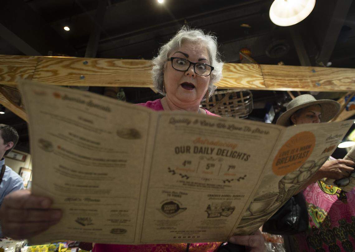 Maria Aguilar emotes at the menu at the Cracker Barrel in Sacramento, Friday, August 17, 2018. The Cracker Barrel opens to the public on Monday, August 20, 2018. 