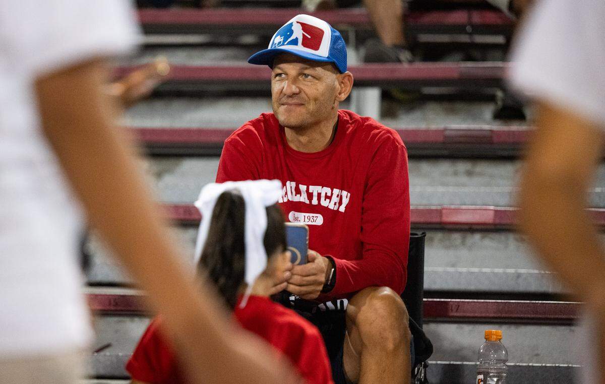 Sacramento Mayor Kevin McCarty wears a McClatchy shirt as he and his family watch the high school play the Davis Blue Devils on Friday at Hughes Stadium in Sacramento. 