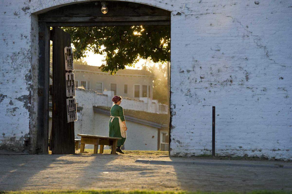 A parent dressed in character stands outside Sutter’s Fort in 2011. The state Department of Parks and Recreation approved a plan Tuesday that will amend the content of learning materials, tours and other guides at Sutter’s Fort State Historic Park to include Native American history and perspectives.