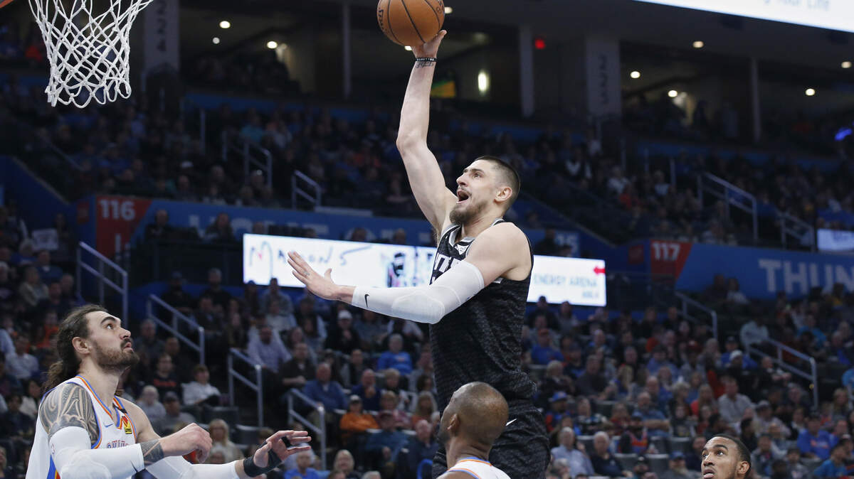 Sacramento Kings center Alex Len, center, shoots between, from left to right, Oklahoma City Thunder center Steven Adams, guard Chris Paul, and forward Terrance Ferguson in the first half of an NBA basketball game Thursday, Feb. 27, 2020, in Oklahoma City. (AP Photo/Sue Ogrocki)