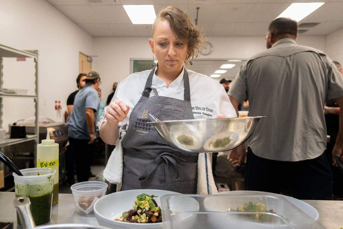 Katerina Balagian, the executive chef at Seasons Kitchen and Bar, prepares her fourth course dish, goat tagine, during this year’s Tower Bridge Dinner menu preview at the Central Kitchen in Sacramento on Monday, Aug. 12, 2024. “Growing up in the United States, I always had my mom make food that was from my culture: Armenian food, a little bit of Baltic food,” Balagian said. “And the one thing that my mom would make that was super American … was shepherd’s pie. So I decided to do a little bit of a play on shepherd’s pie but also keep the elements of a goat tagine.”