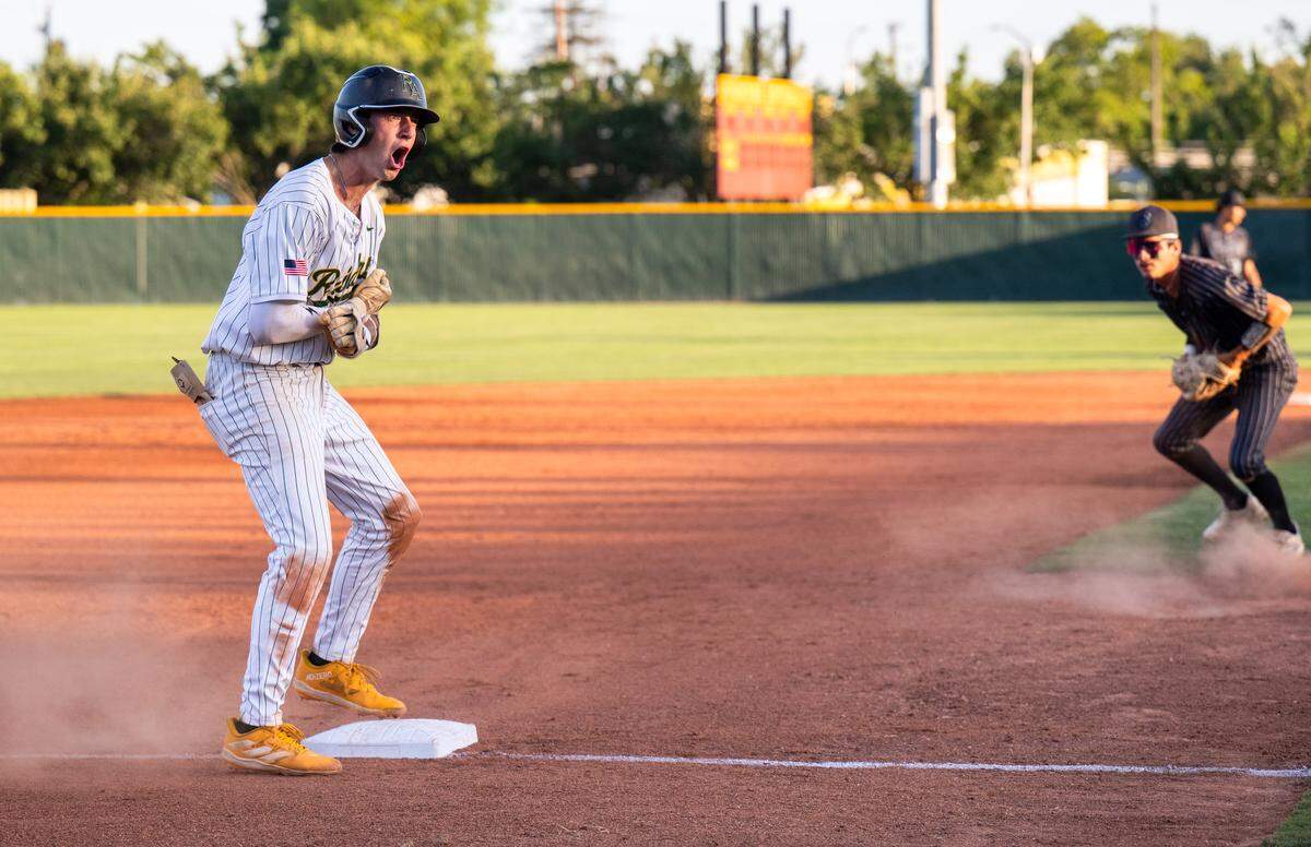 Rio Americano Raiders shortstop Trey Howell-Chase celebrates after sliding into third base for a triple in the fifth inning against the El Capitan Gauchos in the CIF Sac-Joaquin Section Division III baseball championship game at Sacramento City College on Wednesday.