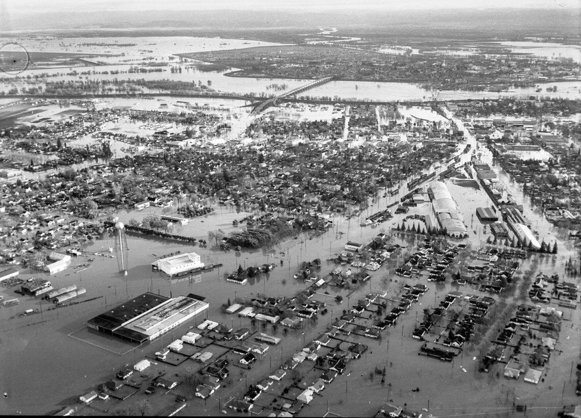 Yuba City, foreground, was flooded in the morning of Dec. 24, 1955, when the rampaging Feather River broke through the levee south of the city. Marysville, background across the river, is an island in a sea of high water. Its residents had crossed the bridge, center, the day before only to have to escape again from Yuba City.