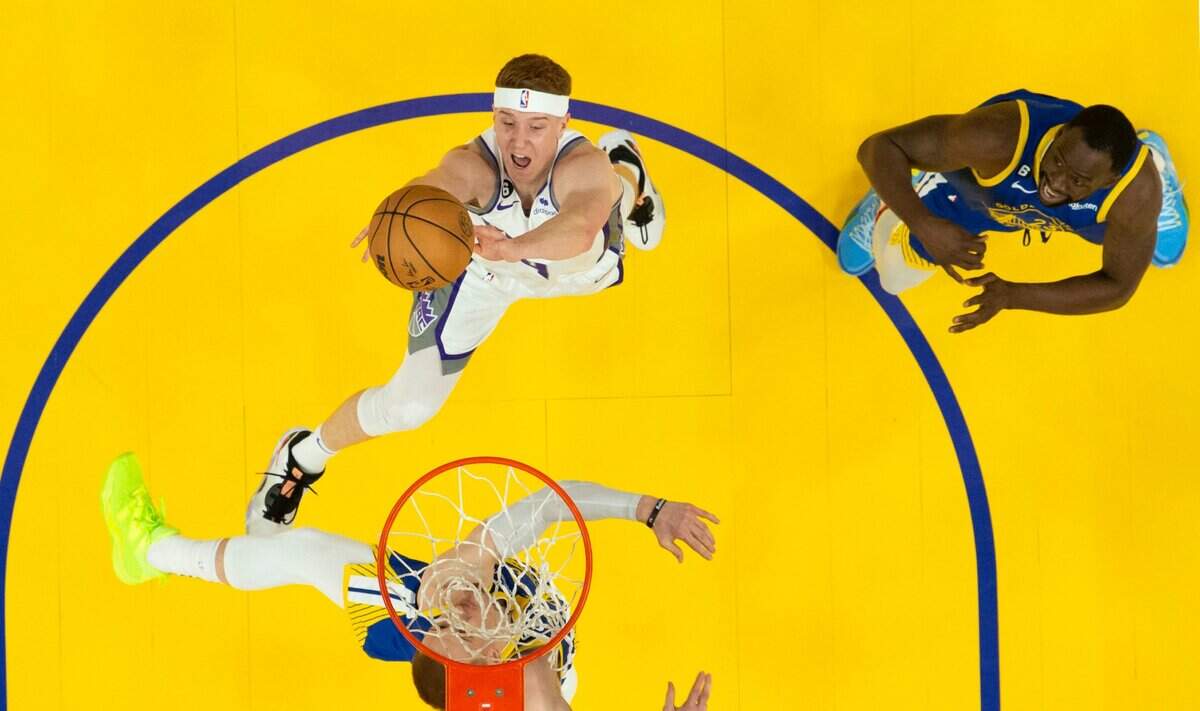 Sacramento Kings guard Kevin Huerter drives to the basket over Golden State Warriors guard Donte DiVincenzo during Game 6 of the first-round NBA playoff series at Chase Center on Friday, April 28, 2023.
