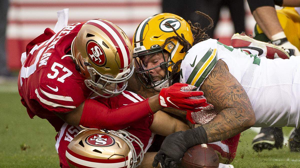 San Francisco 49ers defensive end Nick Bosa (97) and linebacker Dre Greenlaw (57) chase a loose ball after defensive back K’Waun Williams (24) knocked the ball loose from Green Bay Packers quarterback Aaron Rodgers (12) in the second quarter during the NFC Championship at Levi’s Stadium on Sunday, Jan. 19, 2020 in Santa Clara.