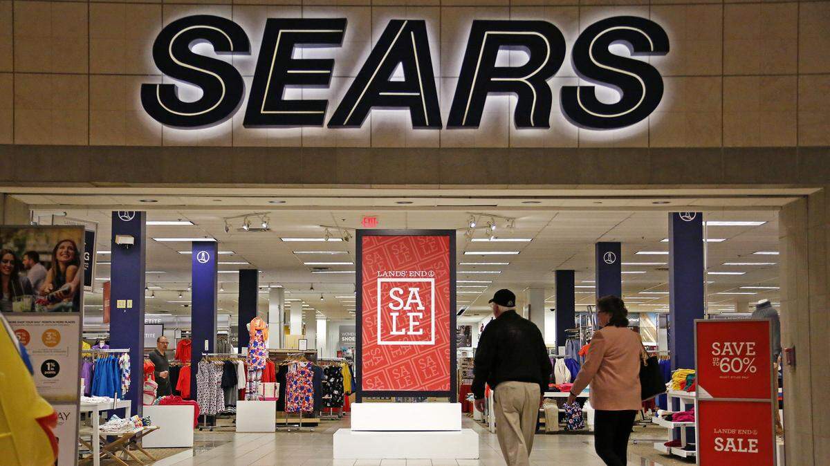Shoppers walk into a Sears store in Pittsburgh. Sears Holding, the corporation which operates Sears and Kmart stores, announced a new set of closures Thursday.