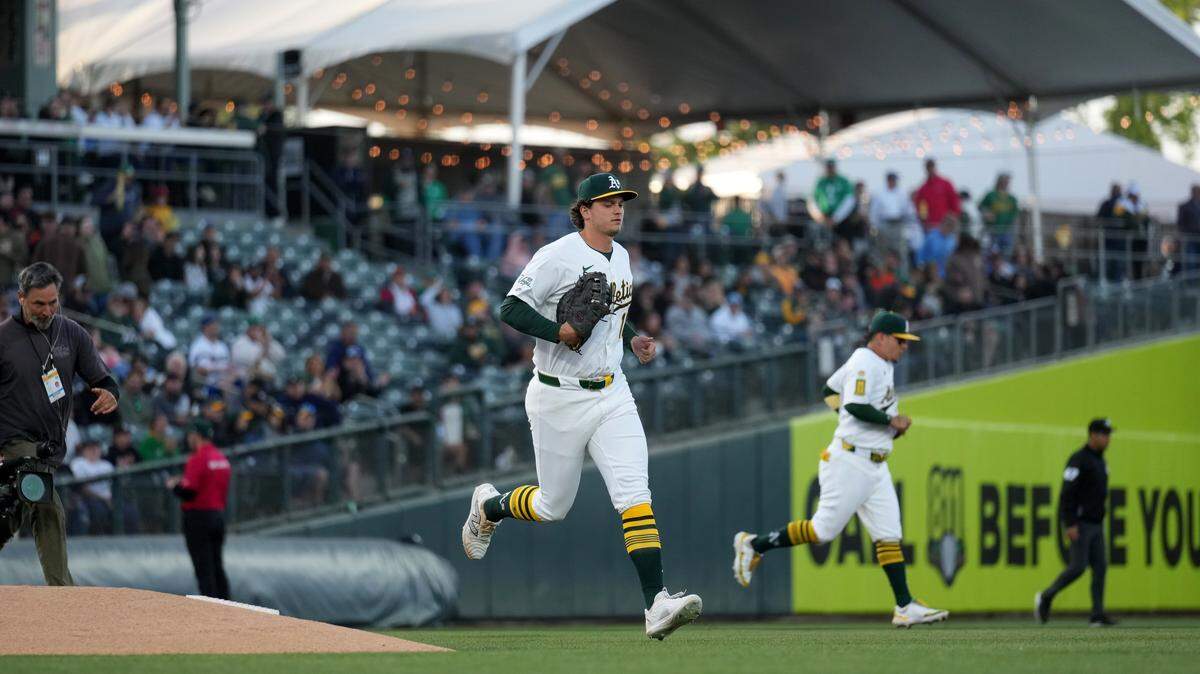 Apr 23, 2025; West Sacramento, California, USA; Athletics first baseman Nick Kurtz (16) jogs onto the field before the start of the game against the Texas Rangers at Sutter Health Park. Mandatory Credit: Cary Edmondson-Imagn Images