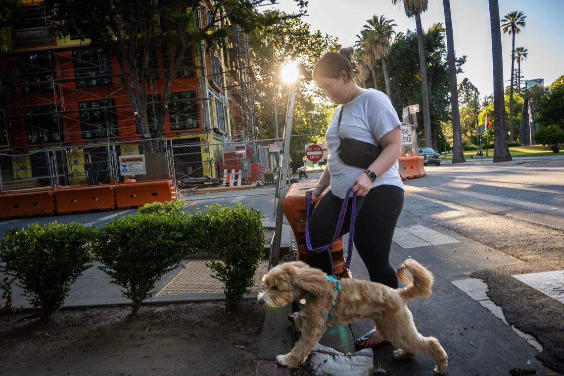 Mary Polon walks with her dog back from a loop near the Capitol on June 28, 2024.