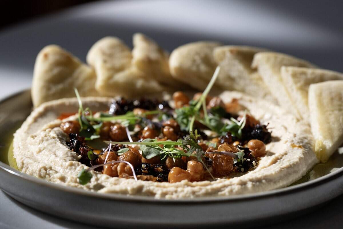 Hummus, sesame chili crisp and scratch-made pita at Aiona in Sacramento on Thursday, April 16, 2026.