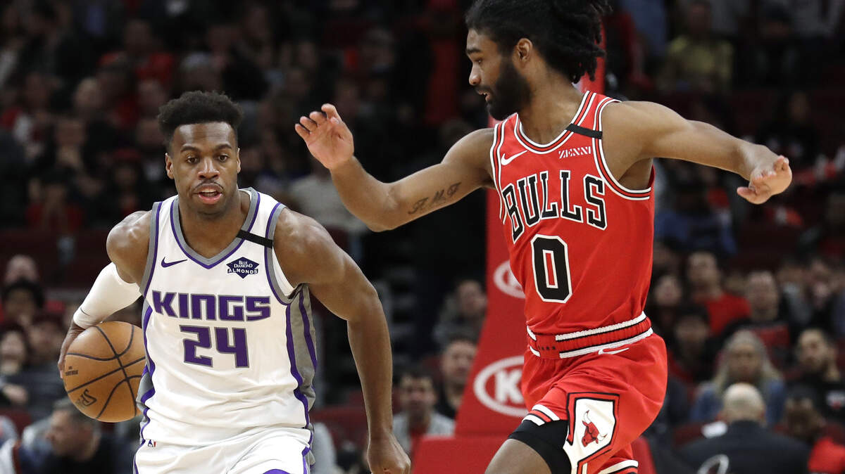 Sacramento Kings guard Buddy Hield, left, controls the ball against Chicago Bulls guard Coby White during the first half of an NBA basketball game in Chicago, Friday, Jan. 24, 2020. (AP Photo/Nam Y. Huh)