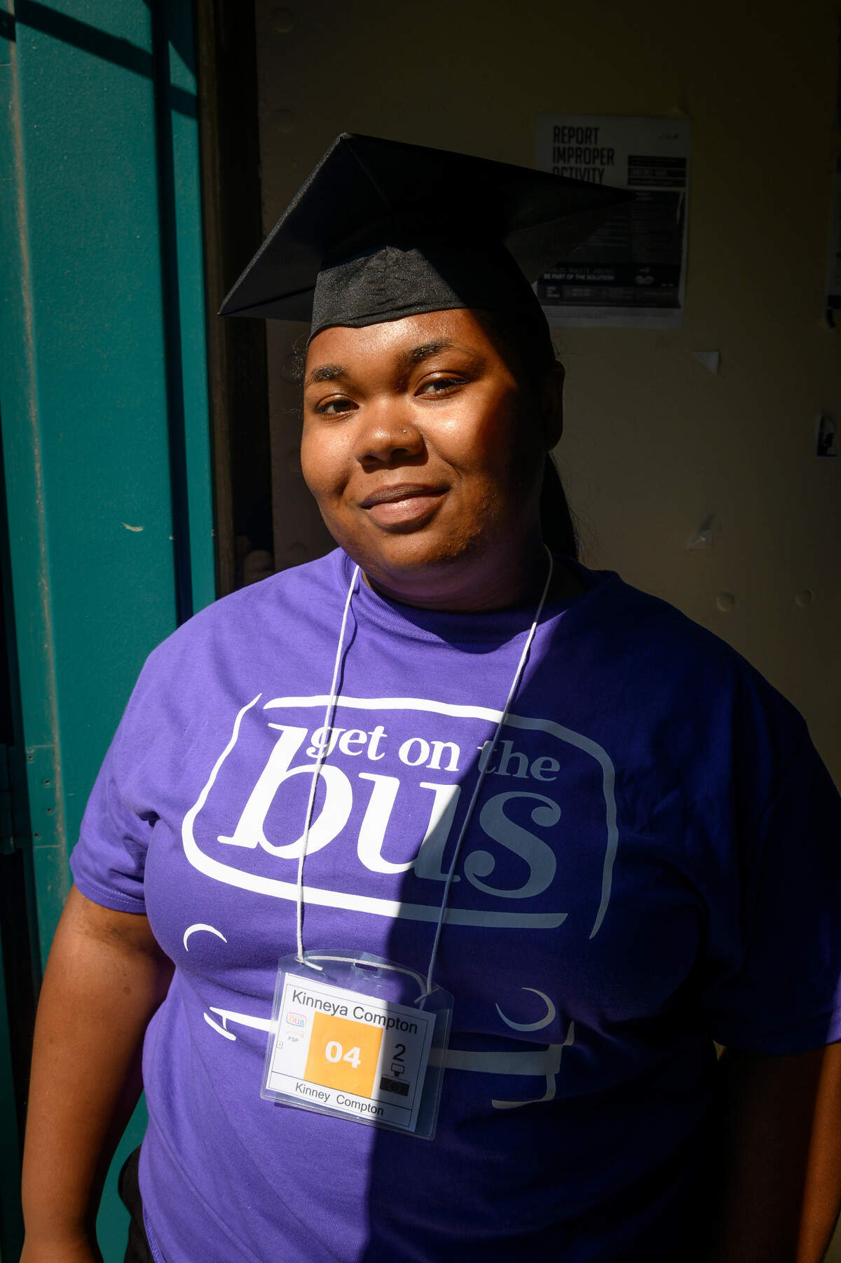 Kinneya Compton wears her graduation cap to celebrate with her father Kinney on Saturday at Folsom Prison during the “Get on the Bus” event, which allowed children to visit their incarcerated parents for an early Father’s Day event.