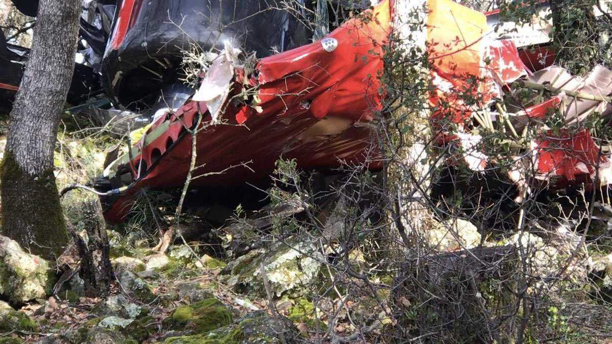 The remnants of a red and black Stinson Vultee V-77 single-engine plane is seen in trees after it crashed Friday, January 24, 2020, about a mile north of Auburn Municipal Airport in Placer County. A father and son, Anthony Lawrence Wright and Anthony Lawrence Wright Jr., have been identified by the Placer Sheriff as the two fatalities.