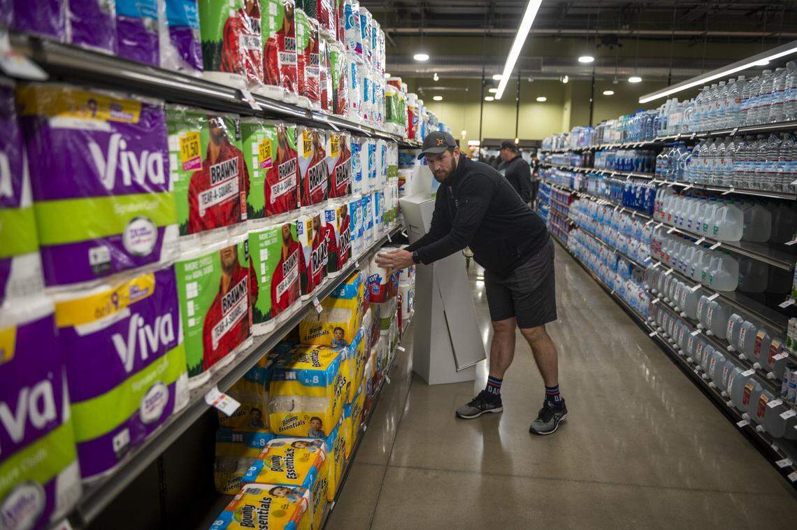 City Councilman Steve Hansen buys paper products on opening day at the new Raley’s in South Land Park in Sacramento on Wednesday.