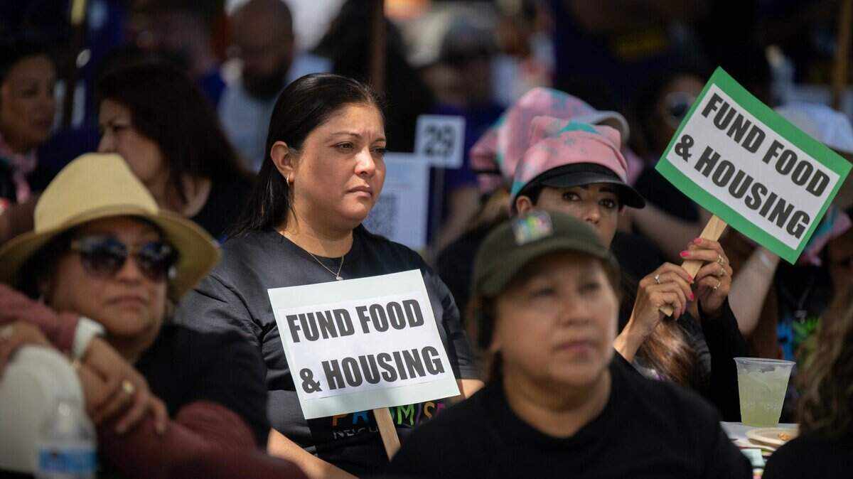 Fabiola Hercules and Leticia Arenas, members of community organization Hayward Promise Neighborhoods, listen to speakers at a rally at the state Capitol on Wednesday, May 15, 2024, with anti-poverty advocates asking for legislative support for those harmed by cuts proposed by Gov. Newsom’s May budget revision to address the state’s deficit.