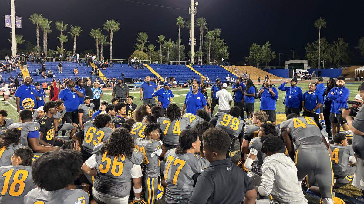 The Grant Pacers take a knee after a 42-26 win Friday, Aug. 29, 2025, over Central East of Fresno at Grant Union High School in Sacramento’s Del Paso Heights neighborhood.