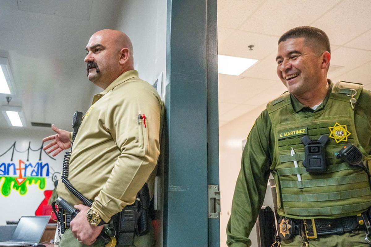 Correctional Officer Edgar Martinez, right, enters the rehabilitation room last month where he and Lt. Joel Gomez, members of the Salinas Valley Resource Team, work with high-risk Level 4 inmates at Salinas Valley State Prison. As part of the California Model, the team participates in activity sessions with the inmates “in order to get them to see us as people, not just a badge,” said Gomez.
