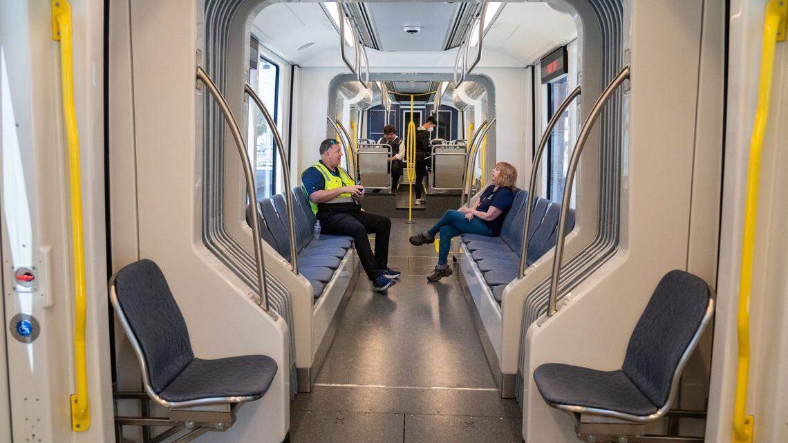 Sacramento Regional Transit workers and members of the public sit inside the air-conditioned S700 low-floor light rail train at the Township 9 station in Sacramento on June 12, 2024. RT’s ZipPass app, which is where riders have purchased and accessed transit passes, will be retired in June, RT spokesperson Jessica Gonzalez said. 