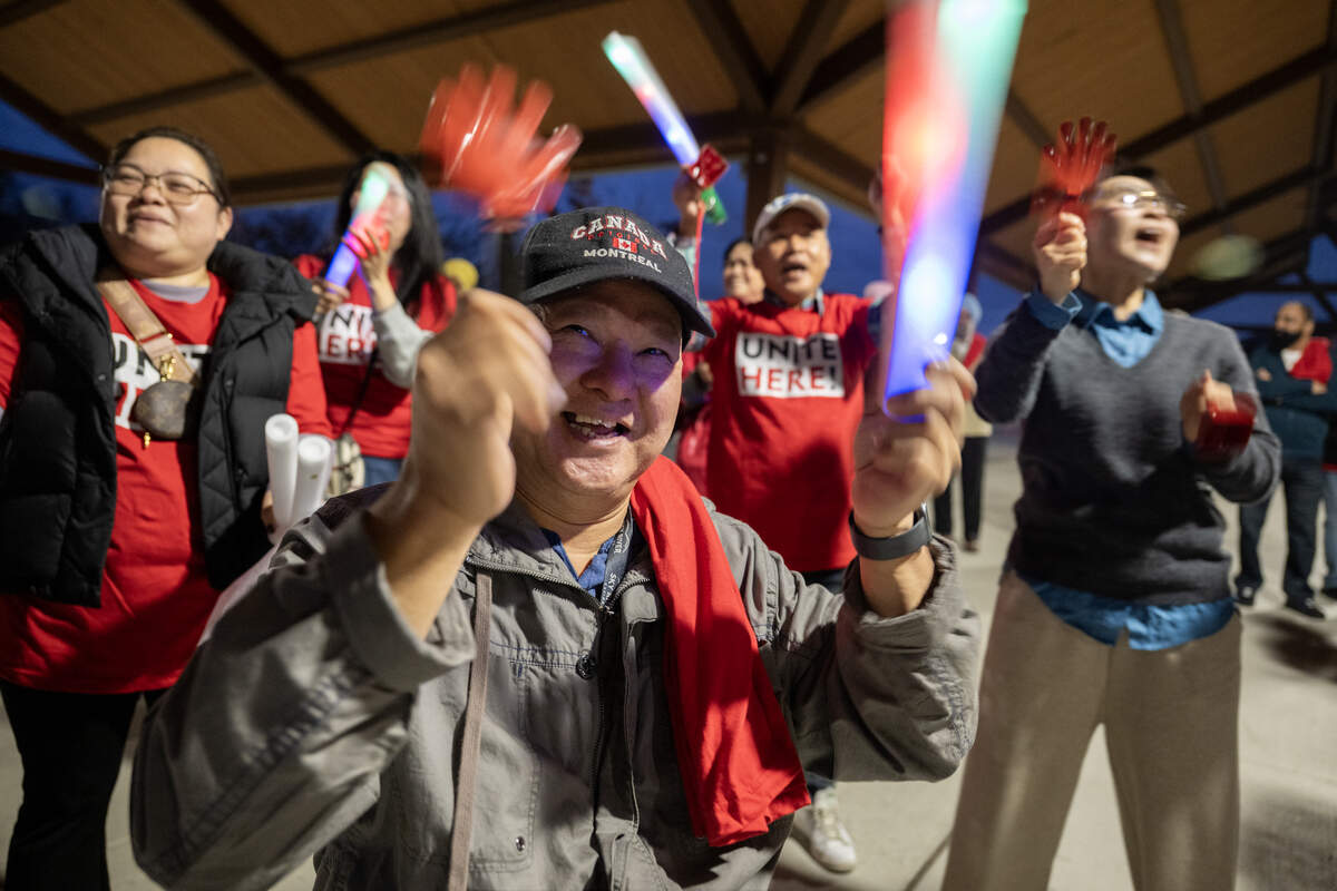 Quong Puong, center, cheers with hotel and casino workers from Sky River Casino at a rally on Tuesday in Old Town Plaza in Elk Grove as they continue to pressure the Wilton Rancheria to negotiate a contract.