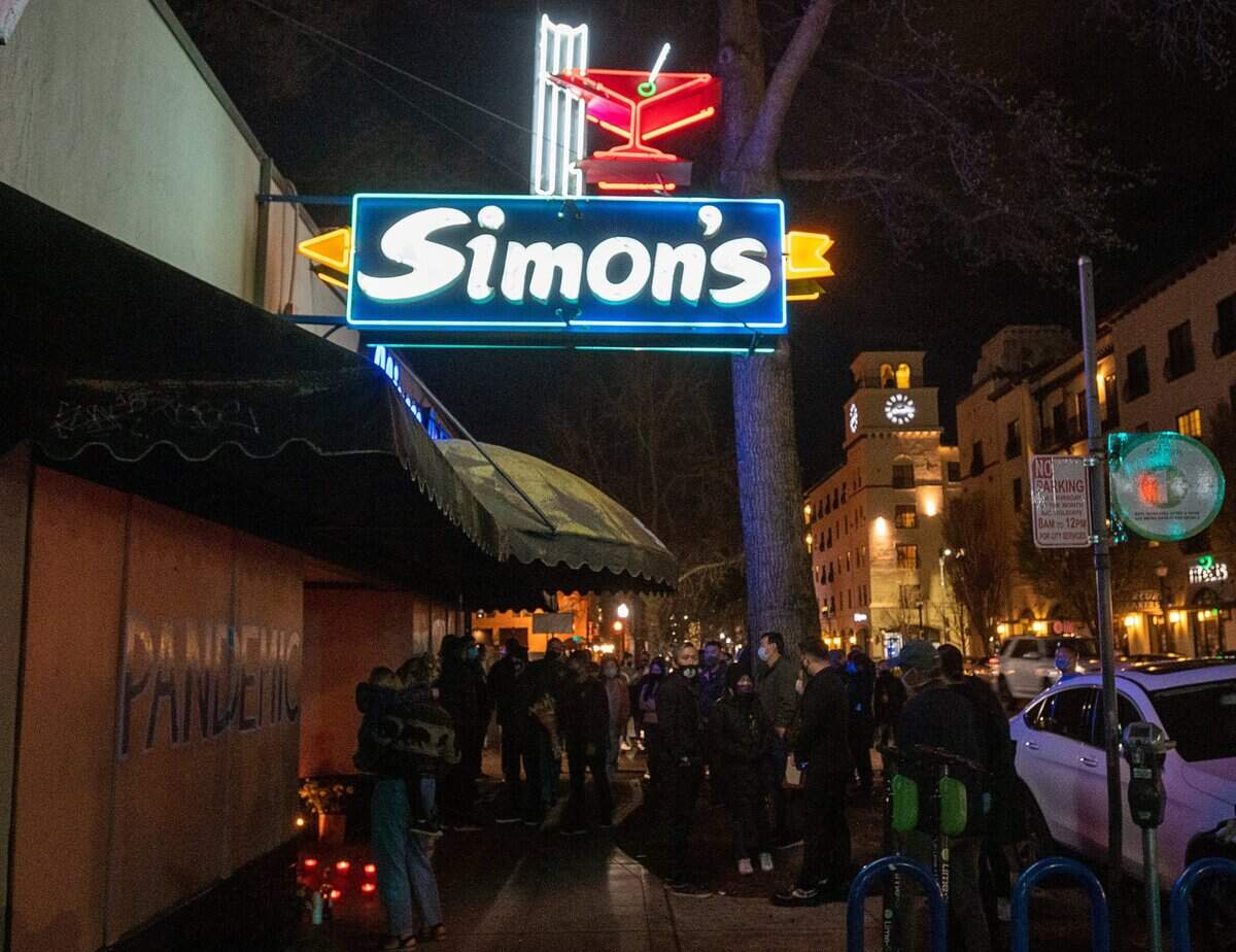 13. The neon sign of Simons Bar & Cafe is turned on as family and friends of Simon Chan, owner of iconic midtown Sacramento gathering spot, hold a candlelight vigil on Monday, March 8, 2021.