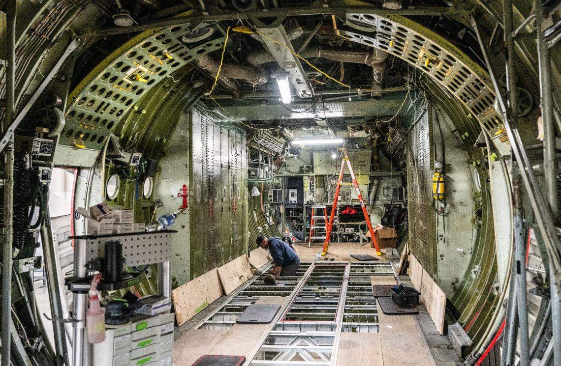 Cal Fire workers prepare a C-130 airframe built in 1984 for its new role as an air tanker on Thursday at McClellan Airport.