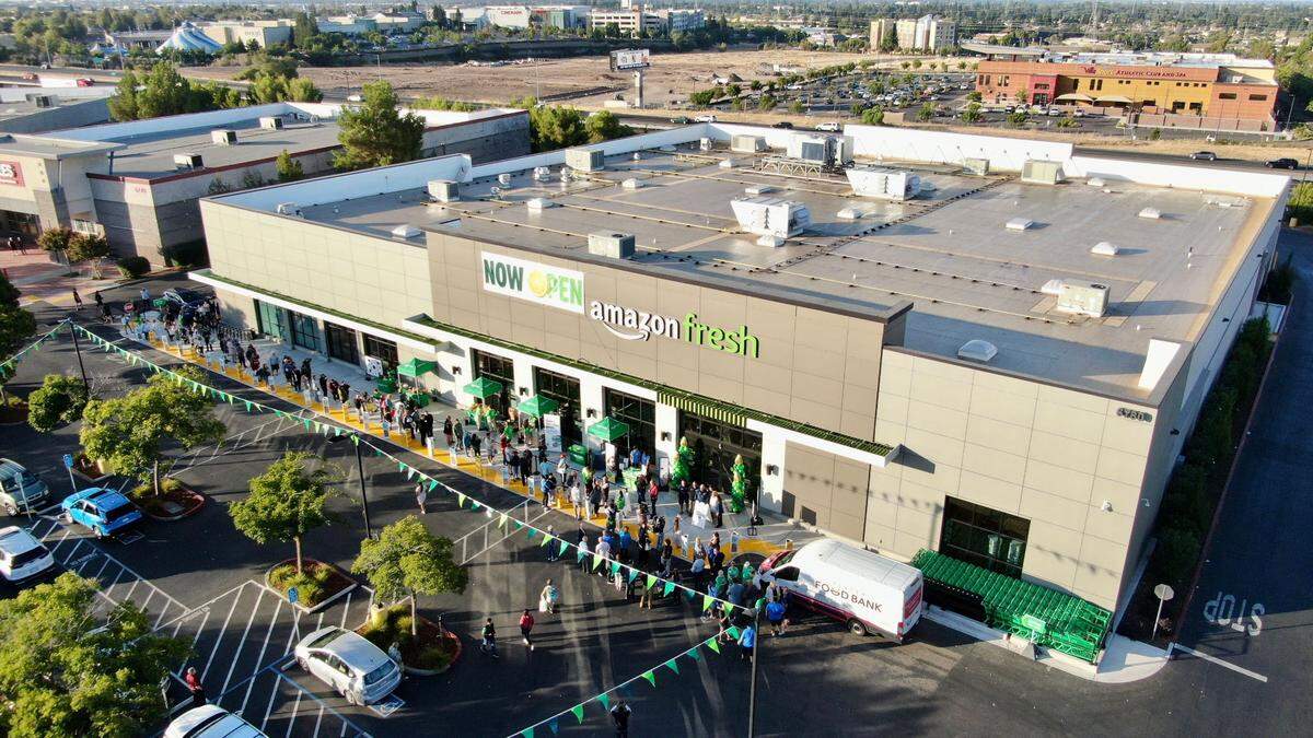 A line of customers waits for the grand opening of the Amazon Fresh store in Roseville on Thursday.