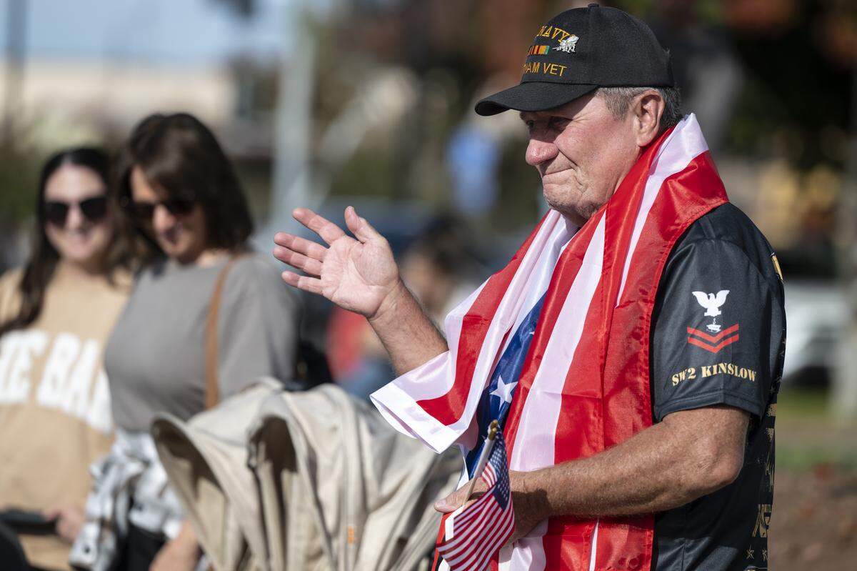 John Kinslow, a former SeaBee, waves to the parade participants during a Veterans Day parade in Folsom on Tuesday, Nov. 11, 2025.