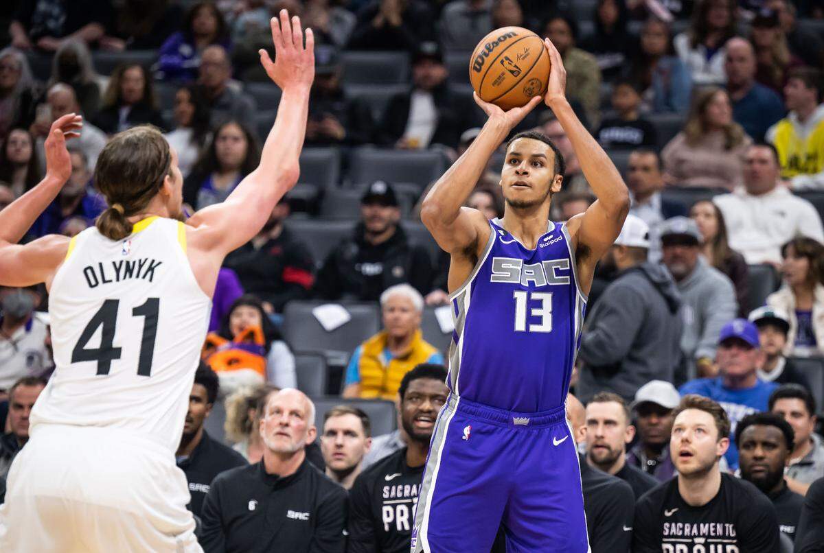 Sacramento Kings forward Keegan Murray (13), right, sinks a three point basket as Utah Jazz forward/center Kelly Olynyk (41) defends early in the third quarter of the NBA basketball game Saturday, March 25, 2023, at Golden 1 Center. The Kings beat the Jazz, 121-113.