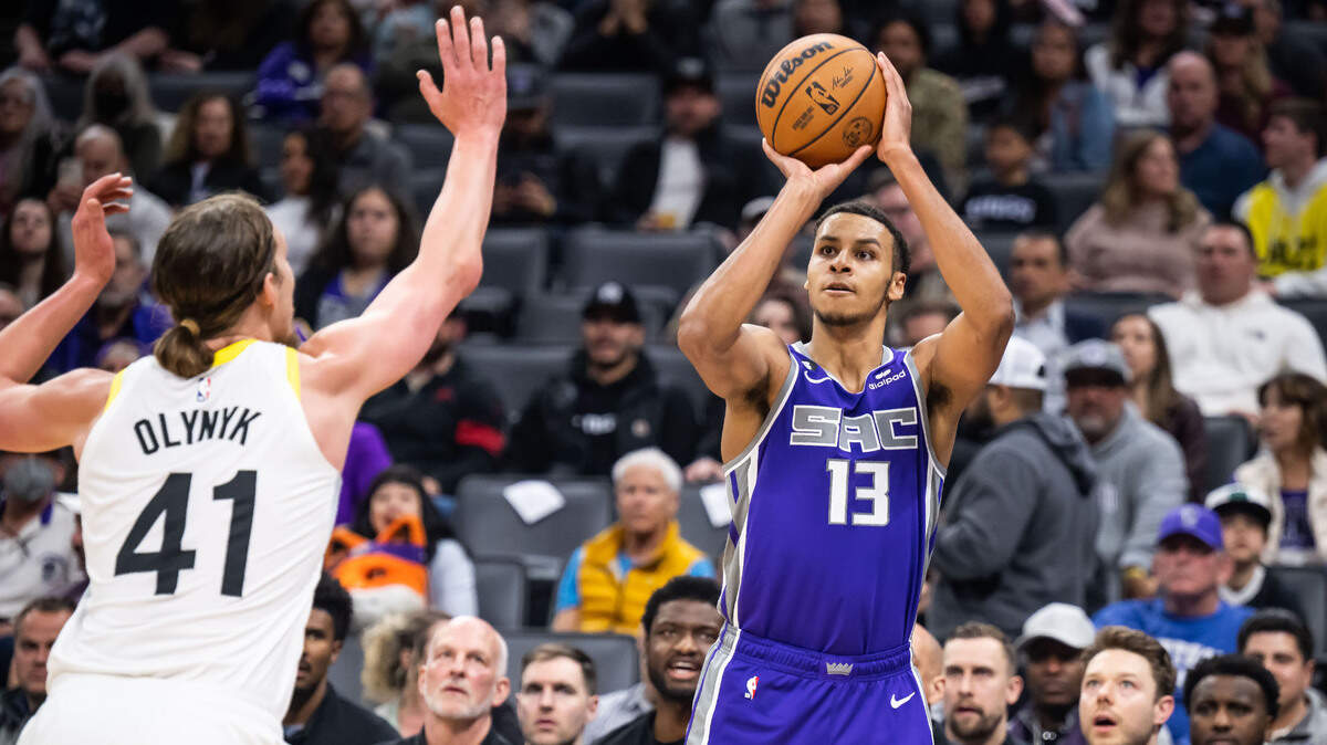 Sacramento Kings forward Keegan Murray (13), right, sinks a three point basket as Utah Jazz forward/center Kelly Olynyk (41) defends early in the third quarter of the NBA basketball game Saturday, March 25, 2023, at Golden 1 Center. The Kings beat the Jazz, 121-113.