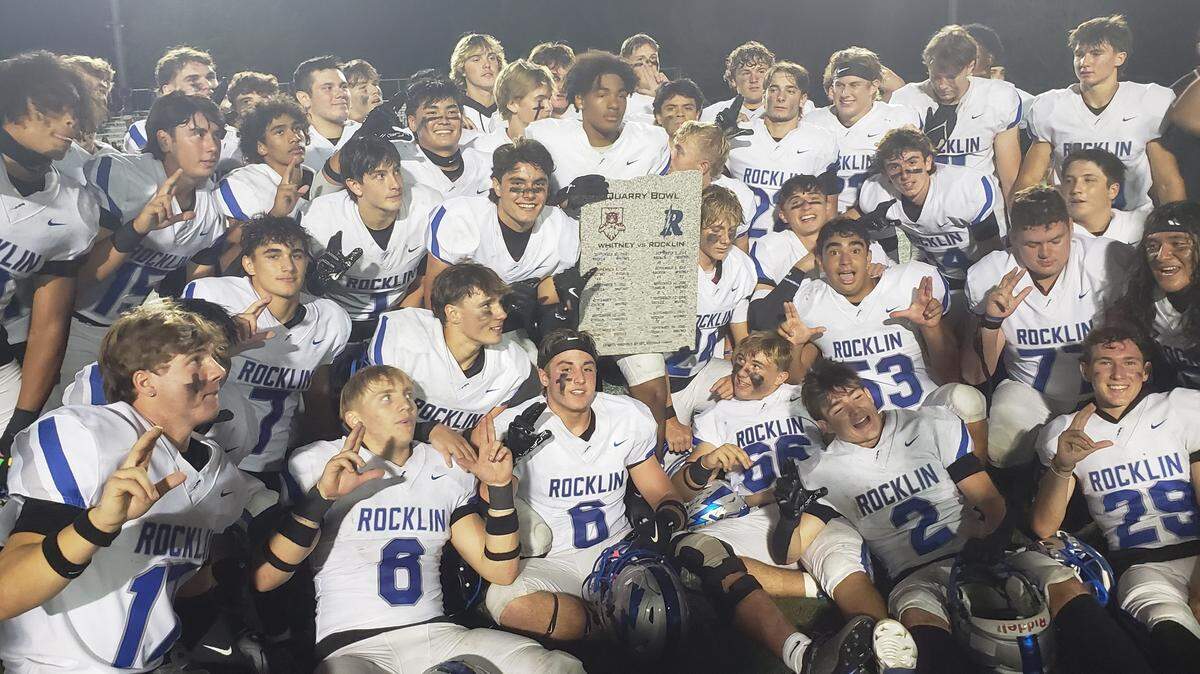 The Rocklin Thunder football team poses with the Quarry Bowl rivalry plaque after defeating Whitney 42-0 on Friday night, Oct. 4, 2024, at Whitney High School in Rocklin.