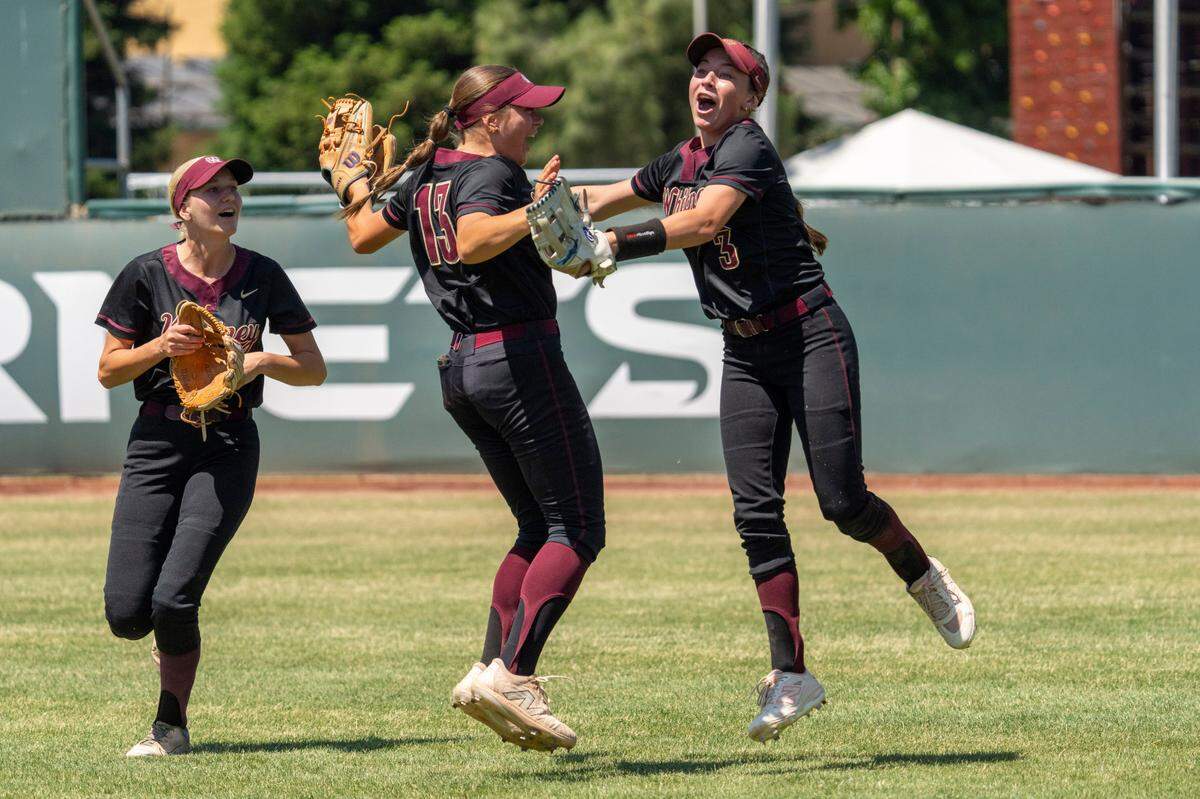 The Whitney Wildcats Bri Seffens celebrates her over-the-shoulder catch with teammates during the 2025 CIF Sac-Joaquin Section Division II championship softball game against the Rocklin Thunder at Sacramento State.