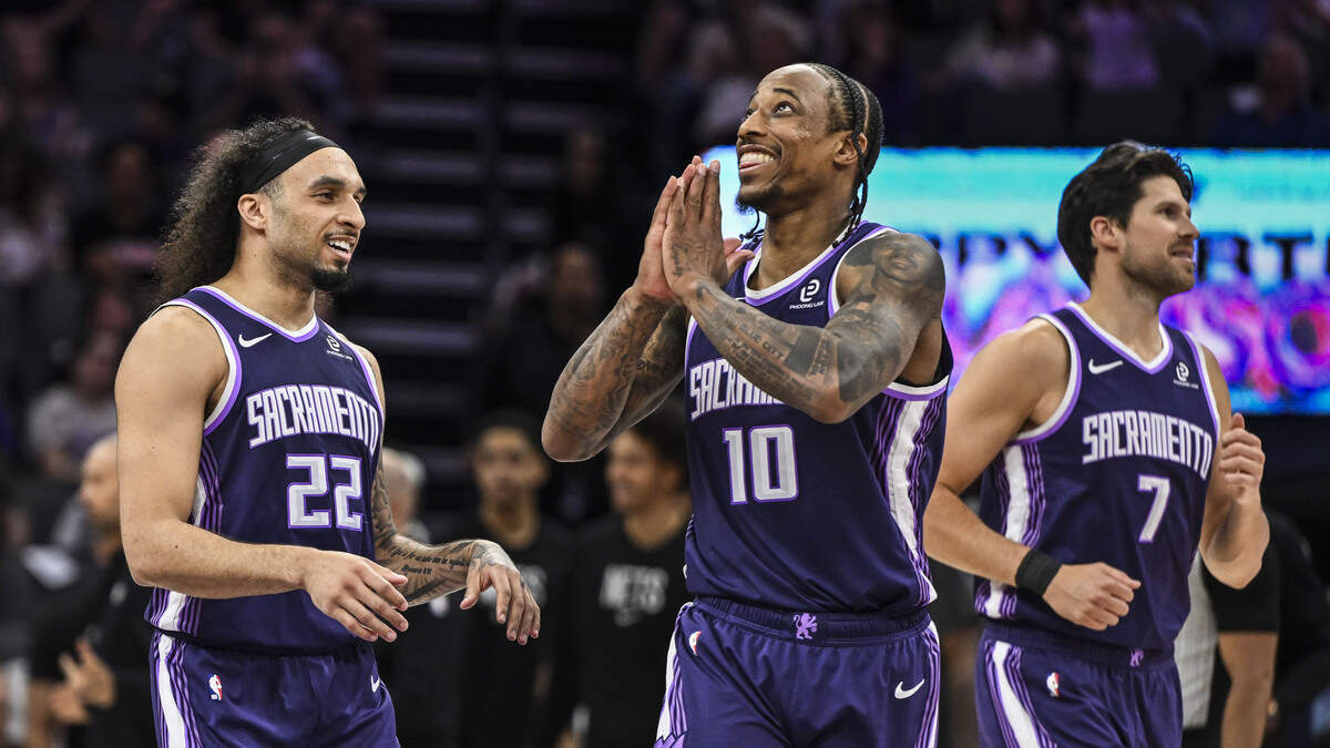 Sacramento Kings guard-forward DeMar DeRozan (10) celebrates a saved ball by teammate guard Devin Carter (22) during the last seconds of the second half at Golden 1 Center on Sunday, March 22.