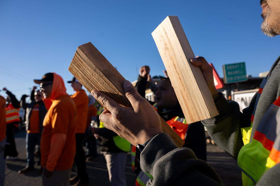 A Nor Cal Carpenters Union member slaps two 2x4s together during a protest at a Sites Reservoir Project meeting in Maxwell as officials vote to finalize the contract to build the reservoir with Barnard Construction on Friday. The union opposes the selection of the out-of-state contractor, citing concerns about safety and budget overruns.