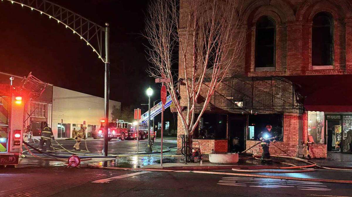 Firefighters are seen mopping up following a blaze at Fourth and D streets in Marysville that gutted the Honey Barn Decor Boutique shop on Monday, Dec. 30, 2024. The shop’s owner has launched a GoFundMe campaign.