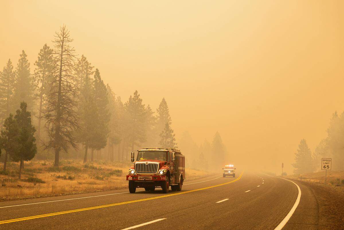 Fire crews make their way through smoke from the Park Fire on Highway 36 northeast of Red Bluff in Tehama County on Saturday, July 27, 2024.