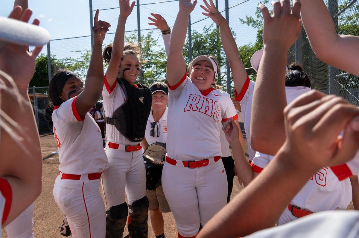 Roseville High’s Art Banks and his players celebrate after scoring against Woodcreek High School on Monday at Roseville High School. Banks is the area’s all-time winningest softball coach and is retiring at the end of the season.