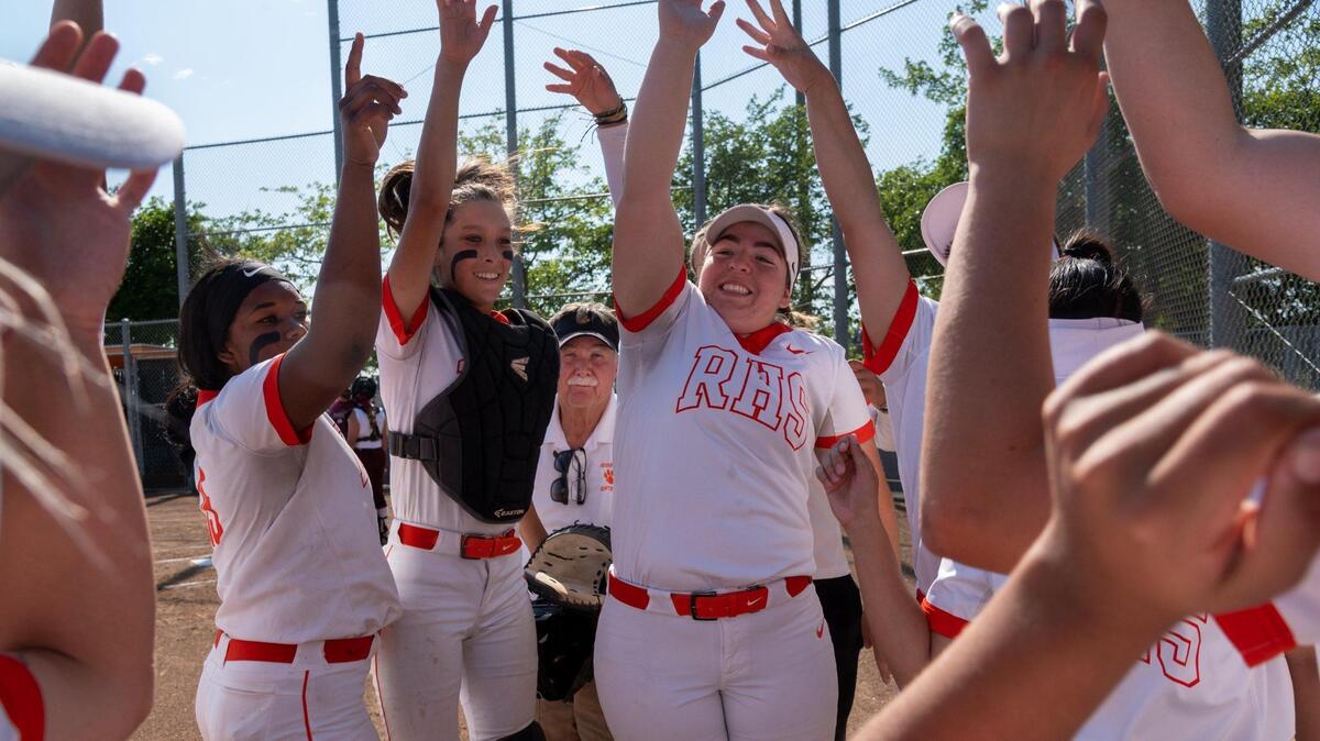 Roseville High’s Art Banks and his players celebrate after scoring against Woodcreek High School on Monday, April 25, 2022, at Roseville High School. Banks is the area’s all-time winningest softball coach and is retiring at the end of the season.