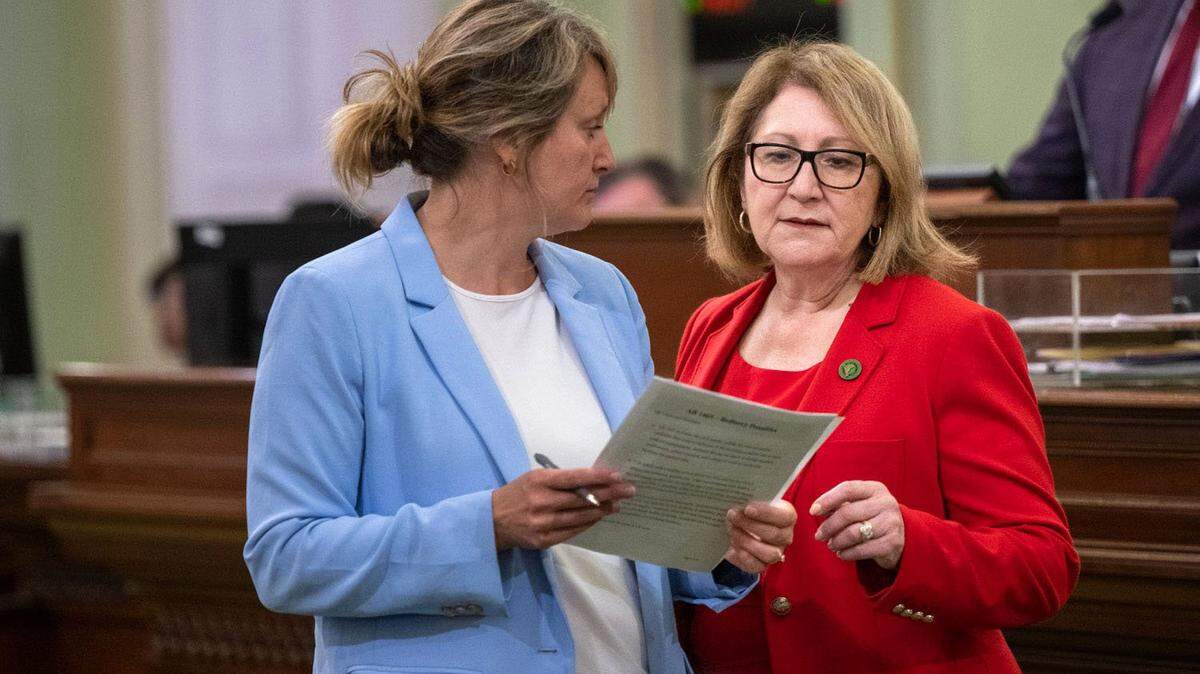 Assemblywoman Eloise Gómez Reyes, D-Colton, right, talks with colleague Buffy Wicks, D-Oakland, during a session in 2023 as a key deadline looms to pass bills.
