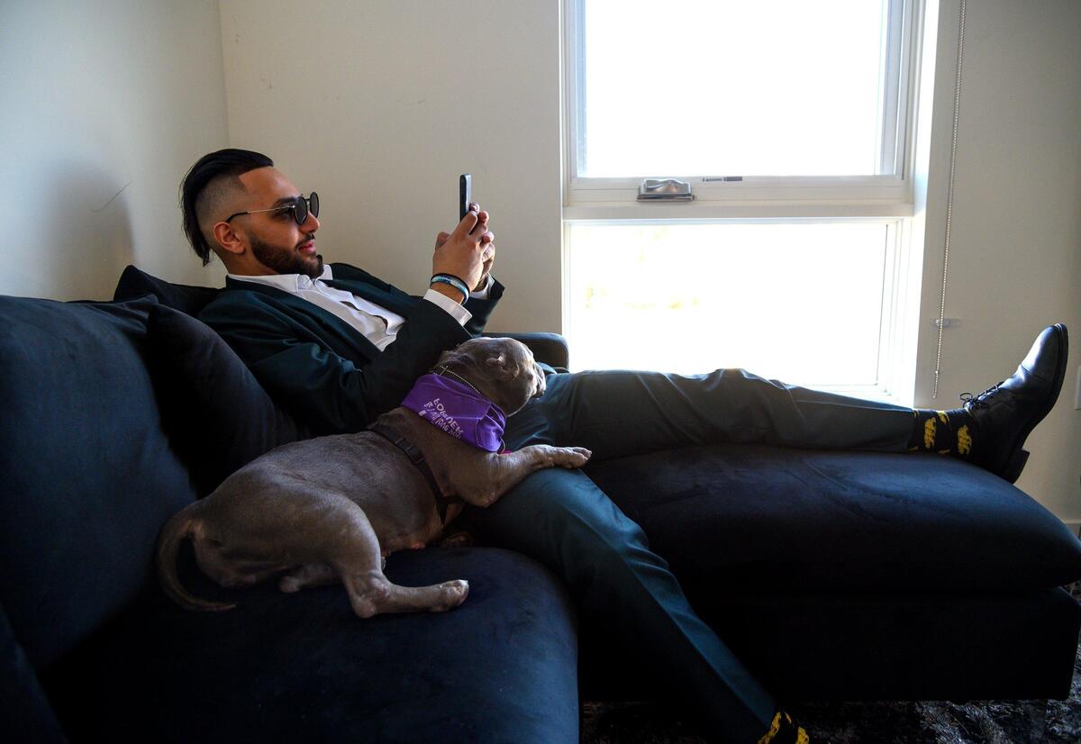 Adoptable dog Lucy Rose sit on the lap of Zayn Silmi in his apartment on Wednesday, January 23, 2019 in Sacramento. Front Street Shelter’s “doggie day out” program lets people rent a dog for a few hours to a day.