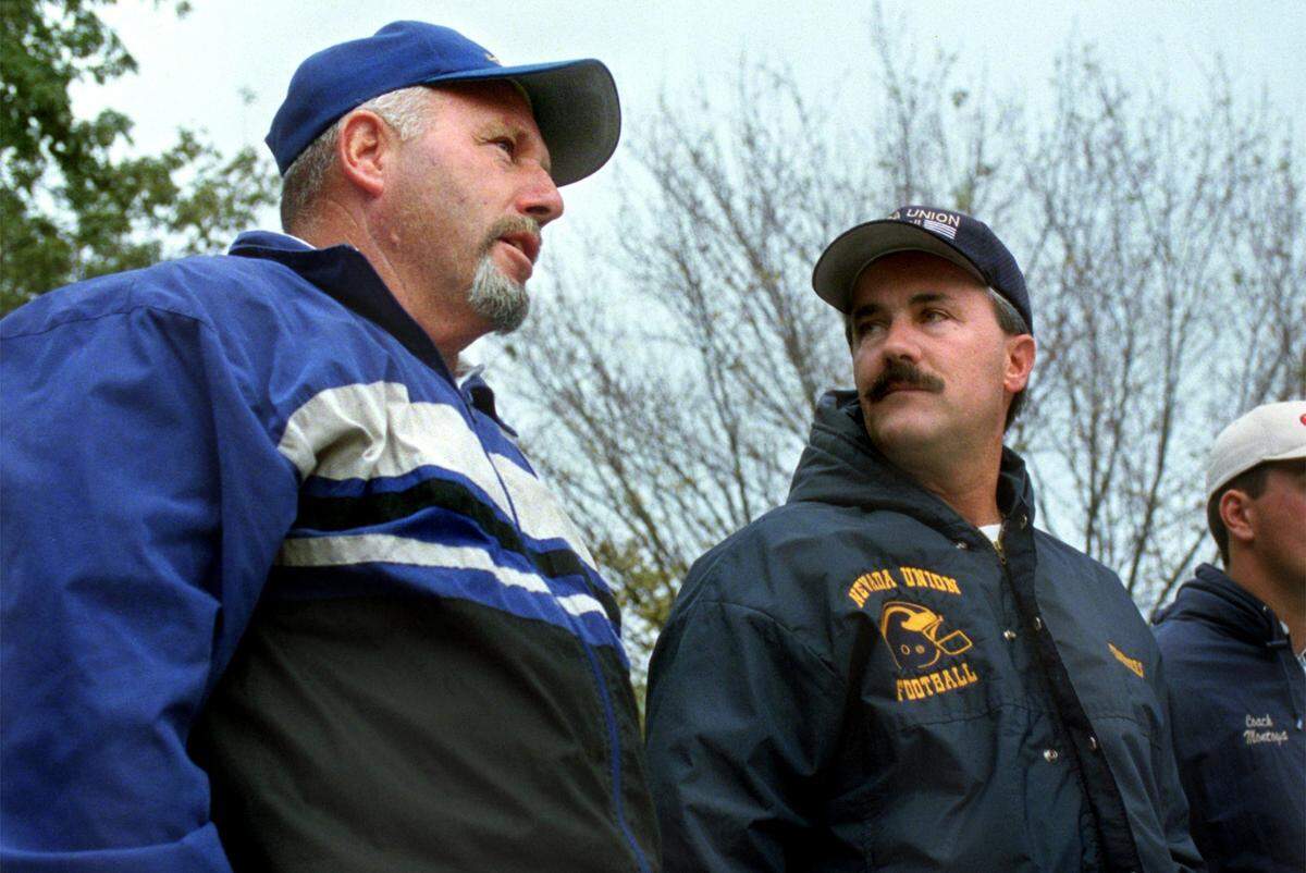Grant High School football coach Mike Alberghini, left, talks with Nevada Union High School football coach Dave Humphers in the stands of Jesuit High School during a game between Jesuit and Florin High School on Saturday, Nov. 9, 2002. The two coaches enjoyed a spirited rivalry in the 1990s and 2000s.