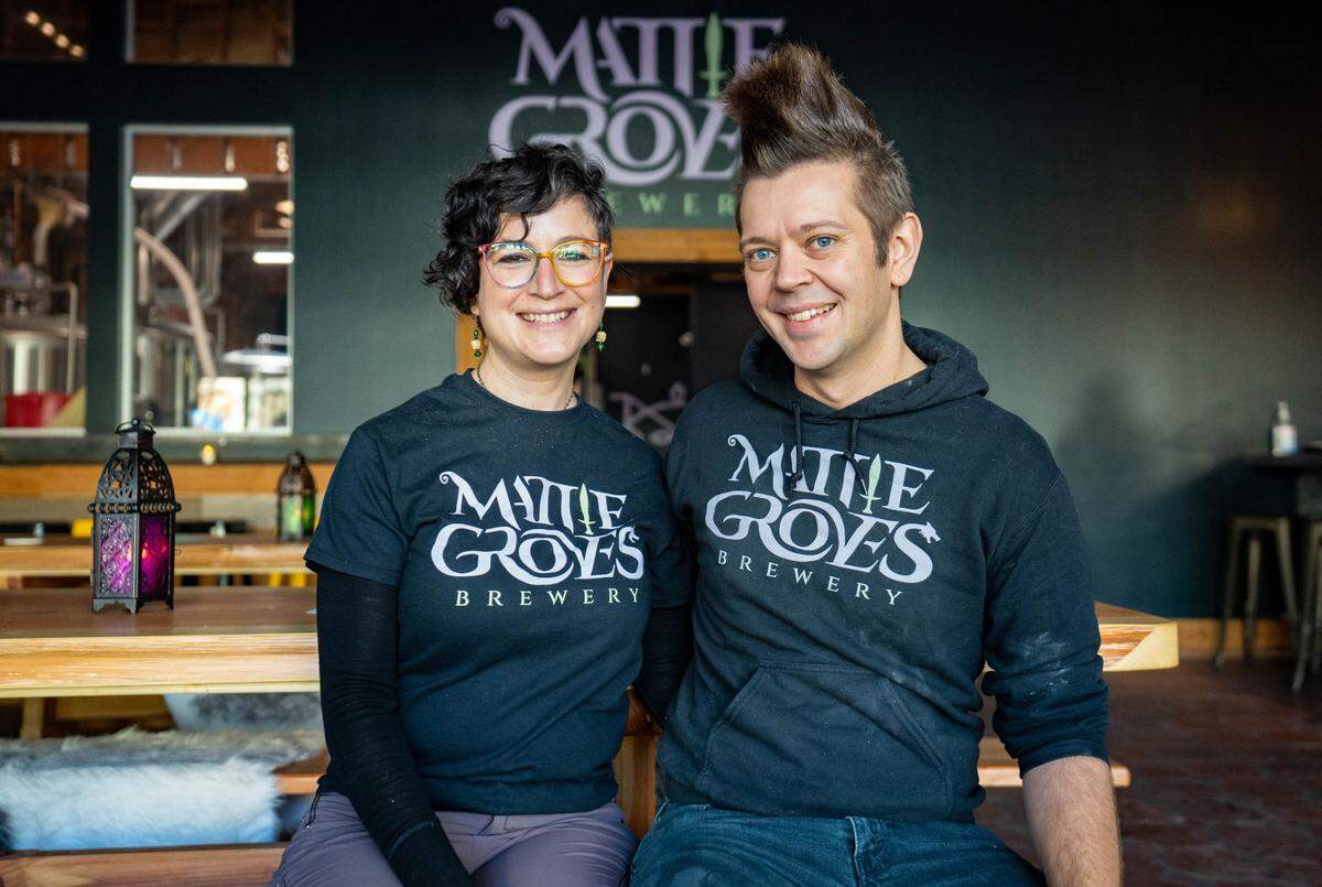 Mattie Groves Brewery co-owners Katie Cooper, left, and Matt Cooper, right, sit in the taproom’s main hall on Thursday, Jan. 4, 2024.