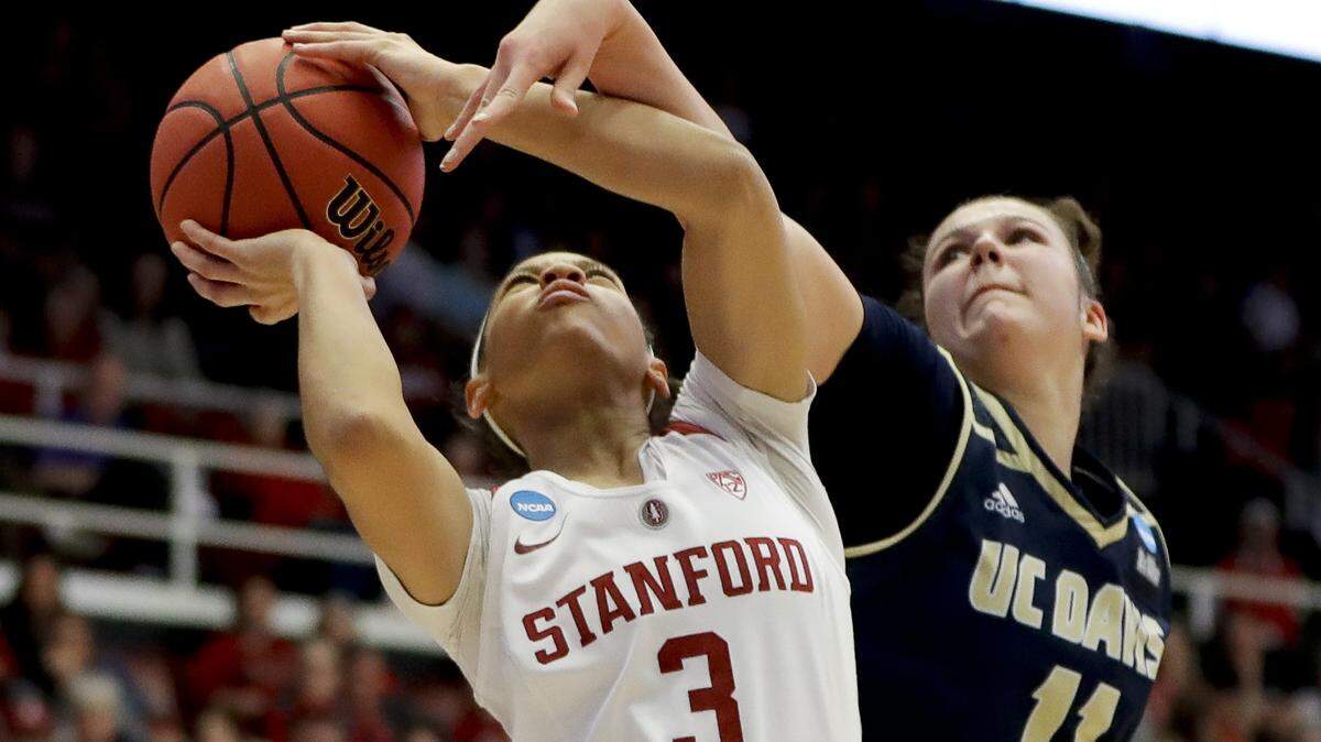 Stanford guard Anna Wilson, left, is fouled by UC Davis guard Sage Stobbart during the first half of a first-round game in the NCAA women’s college basketball tournament in Stanford, Calif. Saturday, March 23, 2019. (AP Photo/Chris Carlson)