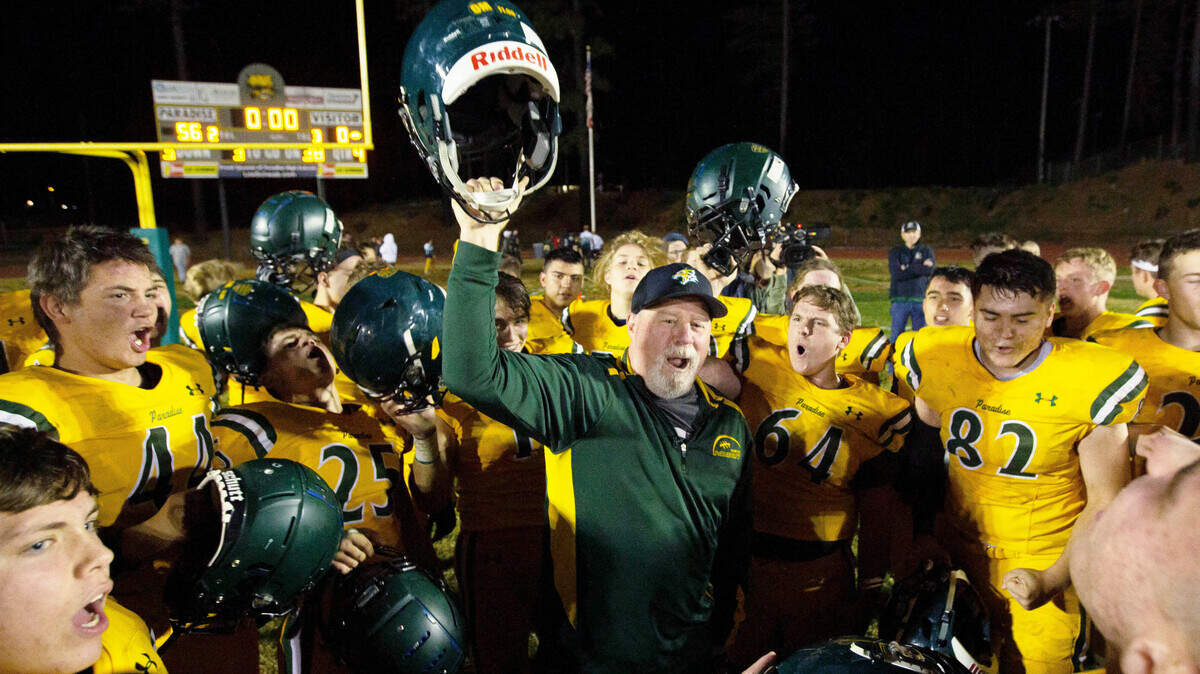 Paradise High School football coach Rick Prinz celebrates with his team after beating Live Oak High School 56-0 in their section Division III playoff game last week.